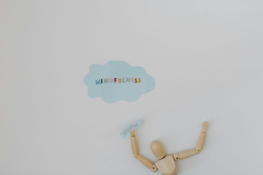 a wooden figure with a sign above it